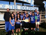 Ocracoke Lady Dolphins show off the paddle they kept after beating Hatteras last week. 